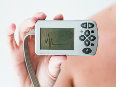 person-hand-holding-monitor-with-cardiogram